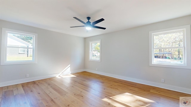 spare room featuring ceiling fan and light hardwood / wood-style flooring