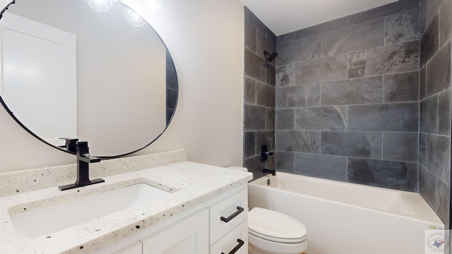 full bathroom featuring vanity, toilet, and tiled shower / bath