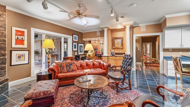 living room with crown molding, visible vents, and decorative columns