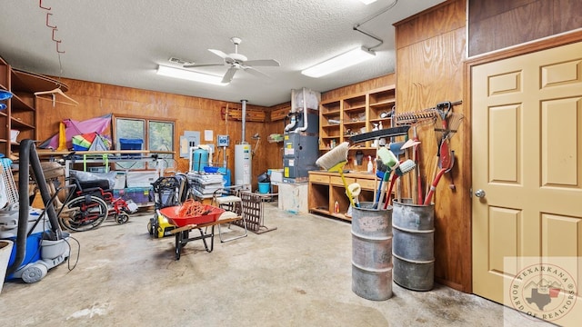 interior space featuring ceiling fan and wooden walls