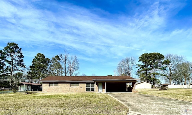 ranch-style home with driveway, a carport, and a front lawn