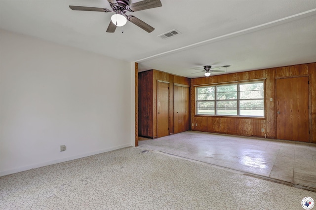 129 Pine St, Maud, TX 75567 - empty room featuring visible vents, a ceiling fan, baseboards, and wood walls