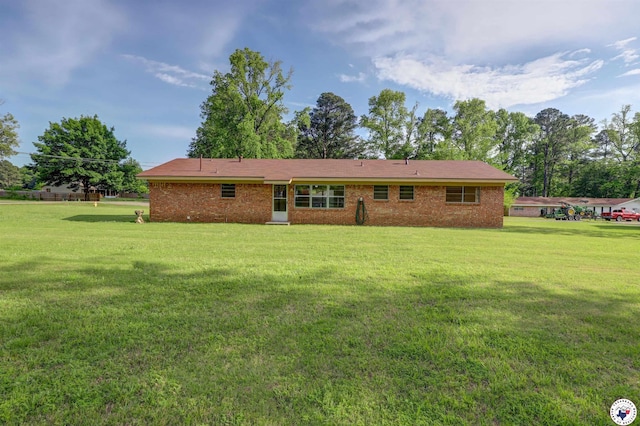 129 Pine St, Maud, TX 75567 - rear view of house with a lawn and brick siding