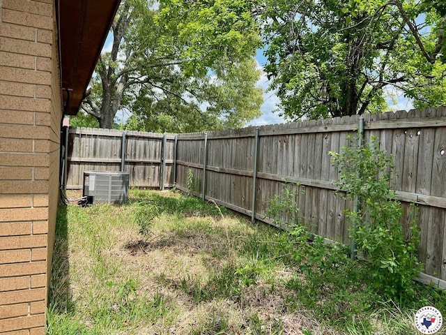 view of yard featuring central air condition unit and a fenced backyard