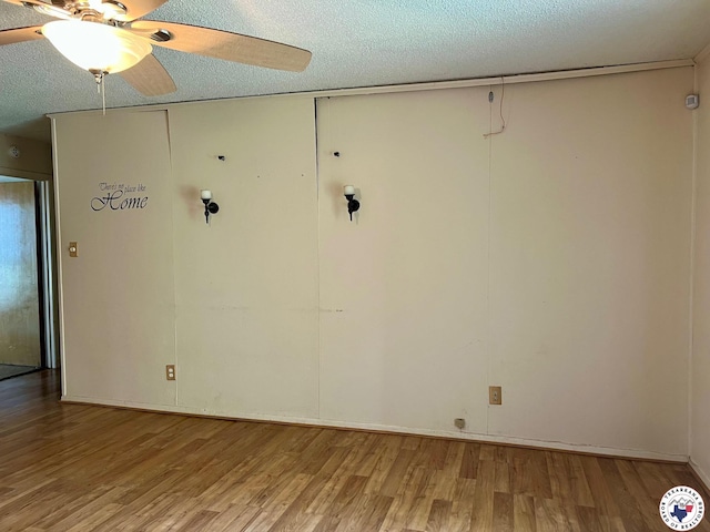 unfurnished room featuring a textured ceiling, wood finished floors, and ceiling fan