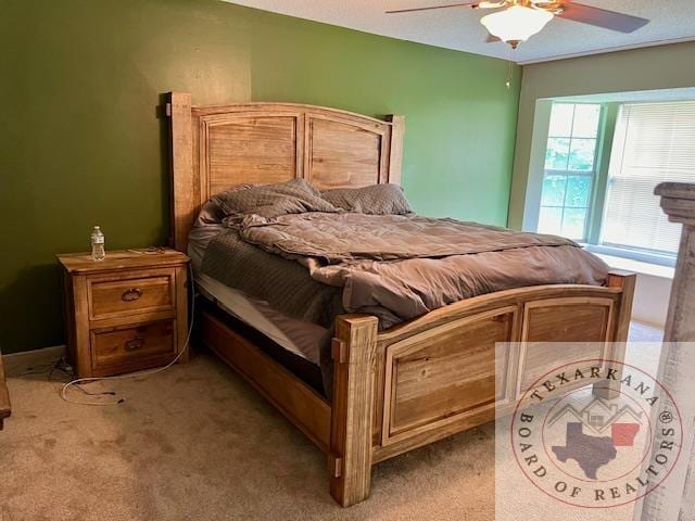 bedroom featuring light colored carpet and a ceiling fan