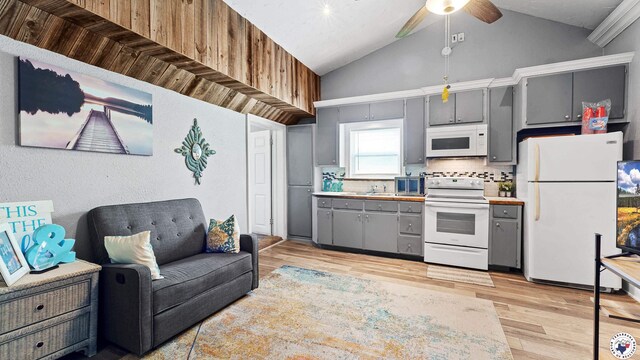 525 Longhorn Rd, Maud, TX 75567 - kitchen featuring white appliances, gray cabinetry, a ceiling fan, light wood-type flooring, and high vaulted ceiling