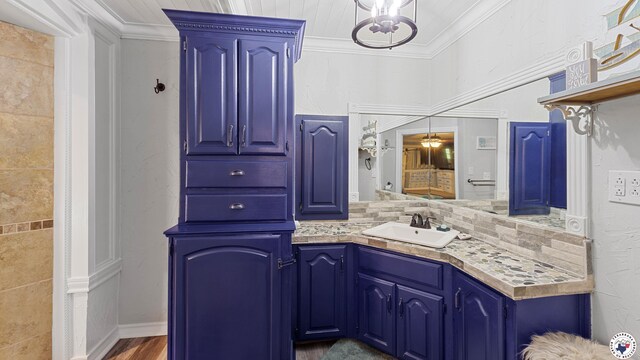 525 Longhorn Rd, Maud, TX 75567 - bathroom featuring ornamental molding, vanity, decorative backsplash, and wood finished floors