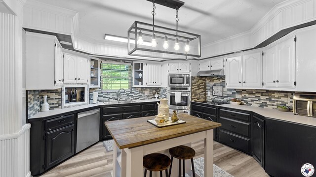 525 Longhorn Rd, Maud, TX 75567 - kitchen featuring dark cabinetry, stainless steel appliances, wooden counters, white cabinetry, and ornamental molding