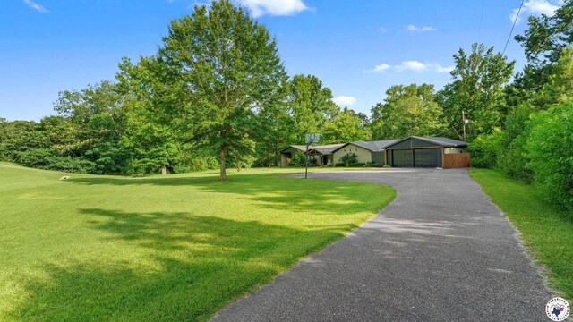 525 Longhorn Rd, Maud, TX 75567 - view of front of home with a front lawn, view of scattered trees, and a detached garage