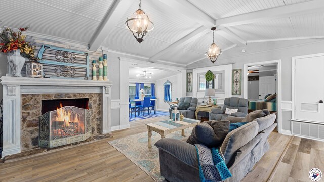 525 Longhorn Rd, Maud, TX 75567 - living room with a chandelier, wood finished floors, a premium fireplace, a wainscoted wall, and a decorative wall