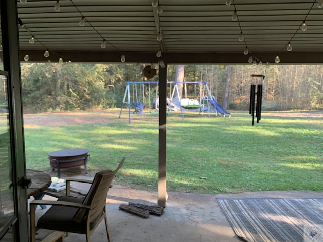 view of yard with a playground and a patio area