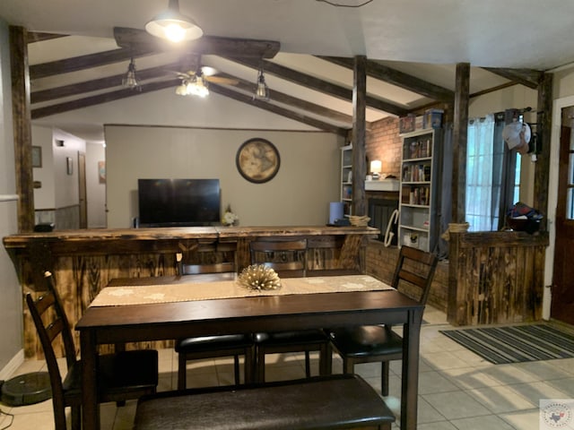 tiled dining room with a fireplace and lofted ceiling with beams