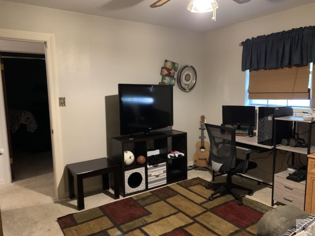 carpeted office space with ceiling fan