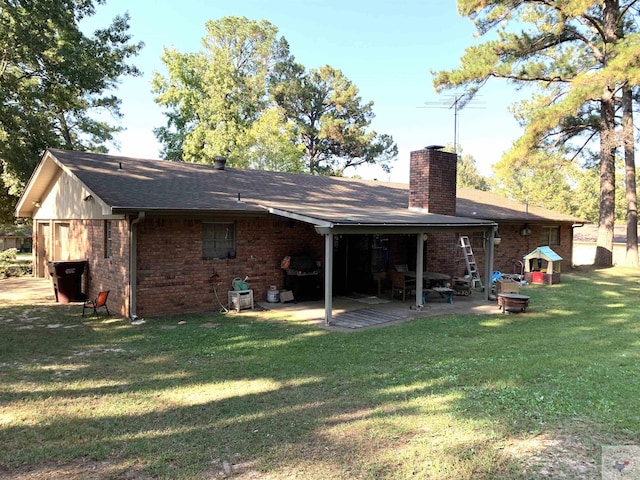 rear view of house featuring a patio area and a lawn