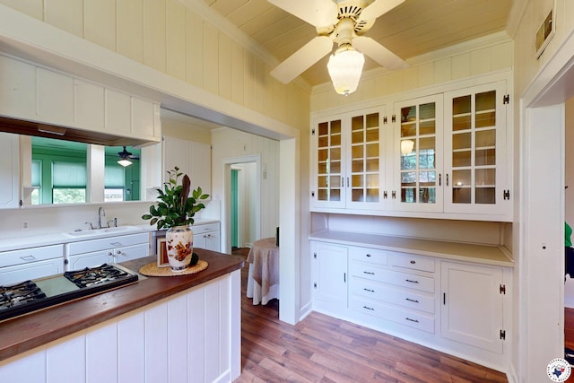 2300 Laurel St, Texarkana, AR 71854 - kitchen with a ceiling fan, white cabinets, gas cooktop, glass insert cabinets, and a wood ceiling with exposed beams