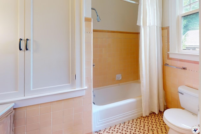 2300 Laurel St, Texarkana, AR 71854 - bathroom featuring tile walls, shower / bathtub combination with curtain, wainscoting, vanity, and tile patterned floors