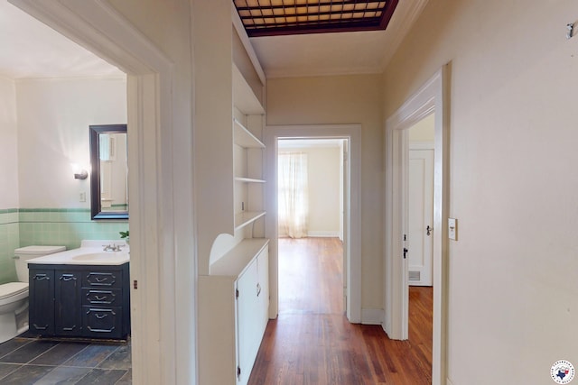 2300 Laurel St, Texarkana, AR 71854 - hallway with ornamental molding, dark wood-style flooring, wainscoting, and tile walls