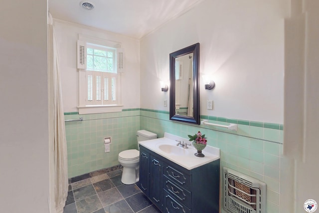 2300 Laurel St, Texarkana, AR 71854 - full bath featuring heating unit, tile walls, a wainscoted wall, vanity, and ornamental molding