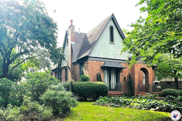 2300 Laurel St, Texarkana, AR 71854 - back of house featuring a chimney, brick siding, stucco siding, and a shingled roof