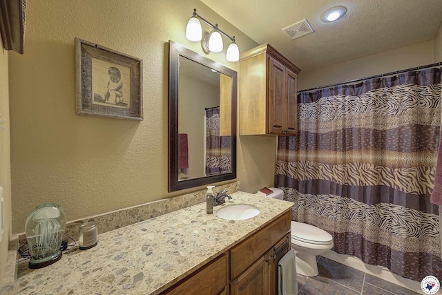 bathroom featuring visible vents, vanity, toilet, a shower with shower curtain, and tile patterned floors