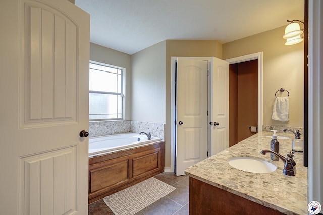 bathroom with a garden tub, a sink, tile patterned floors, and double vanity