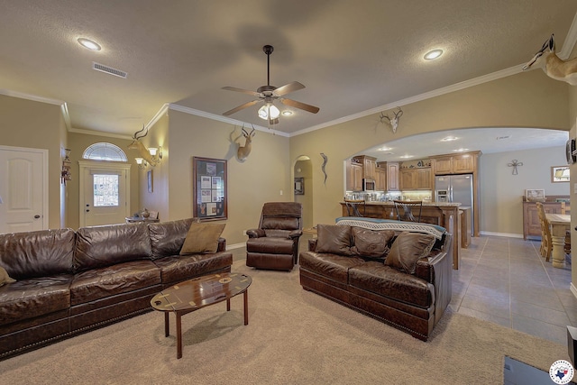 living room with visible vents, a ceiling fan, baseboards, recessed lighting, and arched walkways