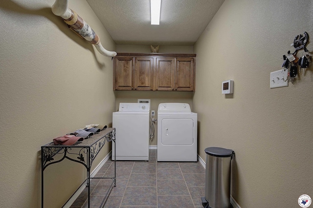 washroom with baseboards, cabinet space, tile patterned flooring, and washer and dryer
