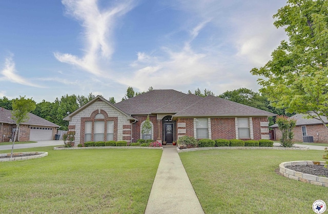 ranch-style home featuring roof with shingles, a front lawn, and brick siding