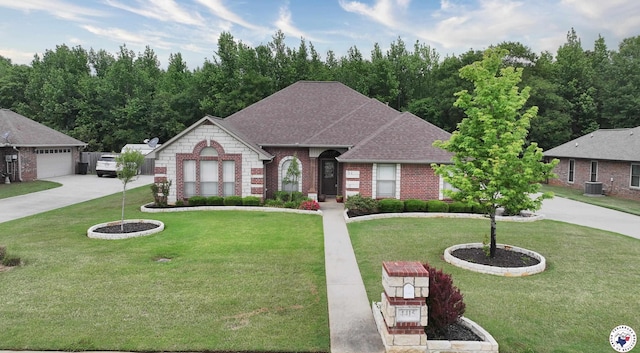 view of front of house with brick siding, central AC unit, roof with shingles, and a front yard
