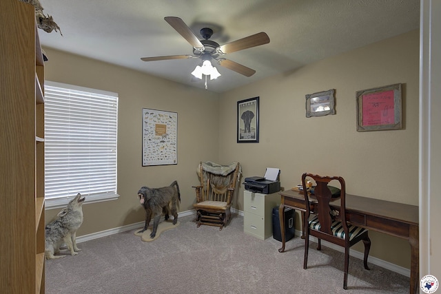 office space featuring carpet floors, ceiling fan, and baseboards