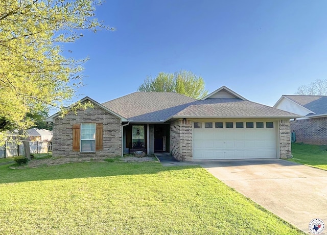 ranch-style home with concrete driveway, brick siding, a front yard, and a garage