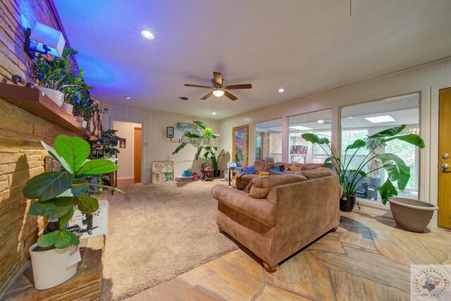 living room with ceiling fan and hardwood / wood-style floors