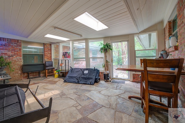 sunroom / solarium featuring wood ceiling and a skylight