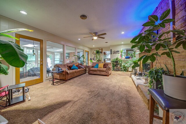 carpeted living room with ceiling fan