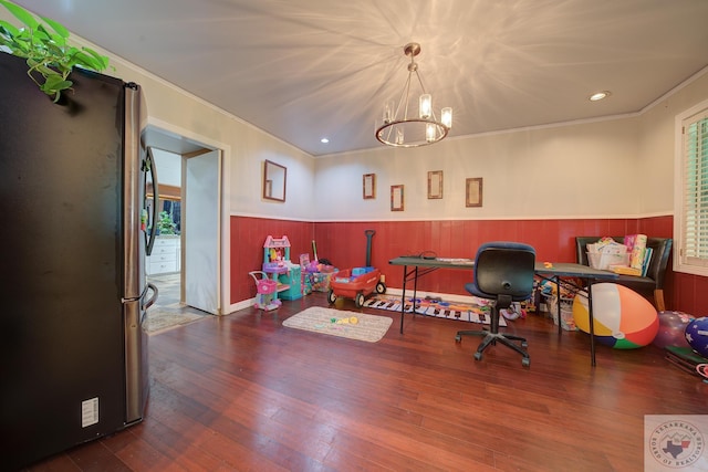 home office featuring wood-type flooring and a notable chandelier