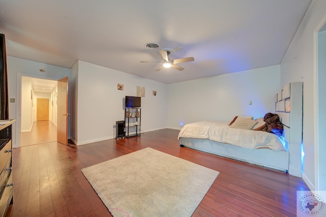 bedroom featuring ceiling fan and dark hardwood / wood-style flooring