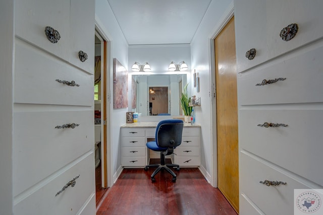 home office with ornamental molding and dark hardwood / wood-style flooring