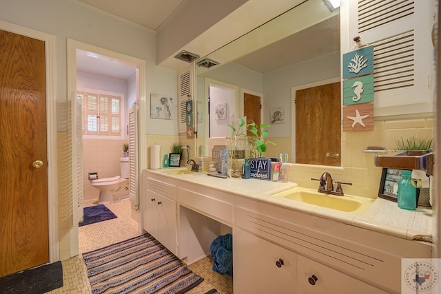 bathroom with tile walls, tile patterned floors, vanity, and toilet