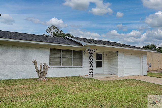 single story home featuring an attached garage, concrete driveway, brick siding, and a front yard