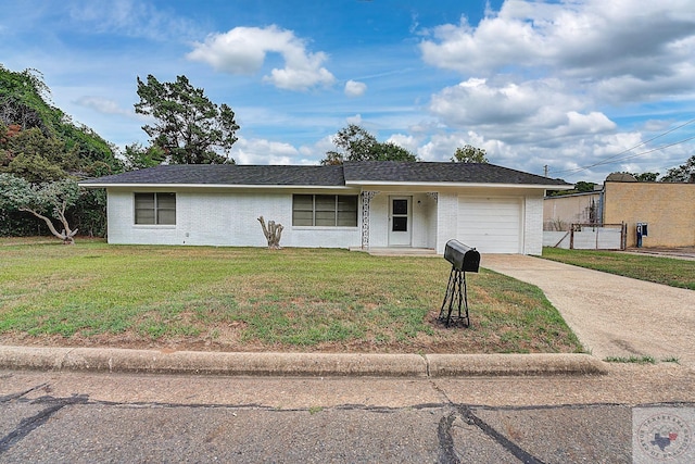 ranch-style house featuring a garage and a front lawn