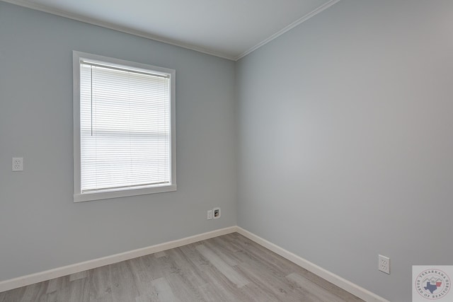 empty room featuring ornamental molding and light wood-type flooring