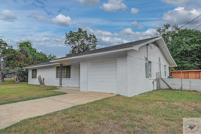 ranch-style house featuring a front yard and a garage