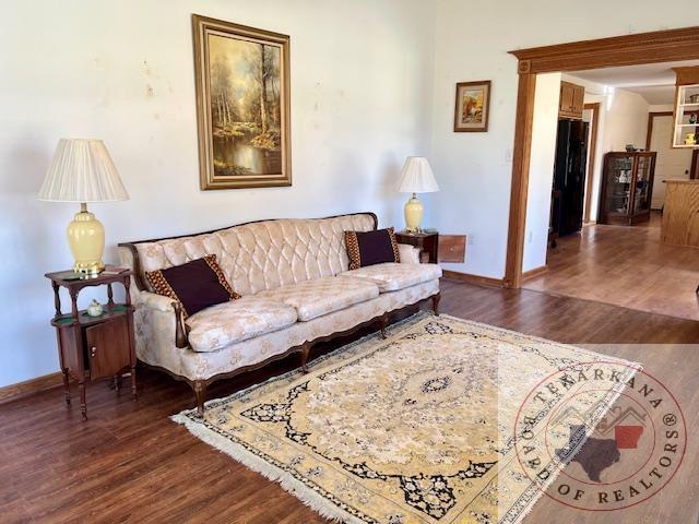 living room featuring baseboards and wood finished floors