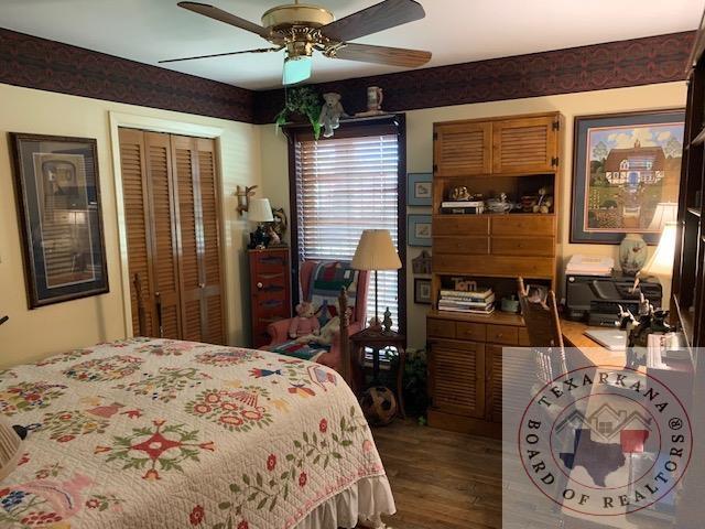 bedroom with a closet, ceiling fan, and hardwood / wood-style floors