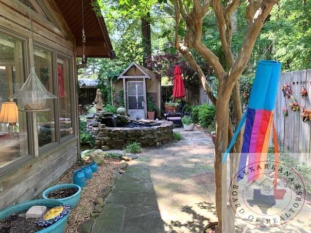 view of patio / terrace with a shed