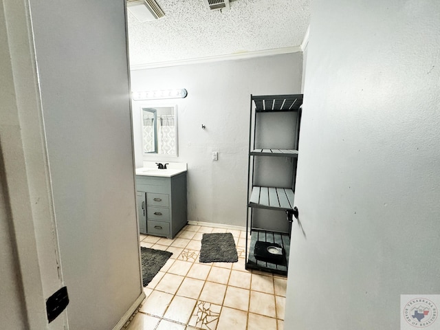 bathroom featuring a textured ceiling, tile patterned floors, vanity, and crown molding