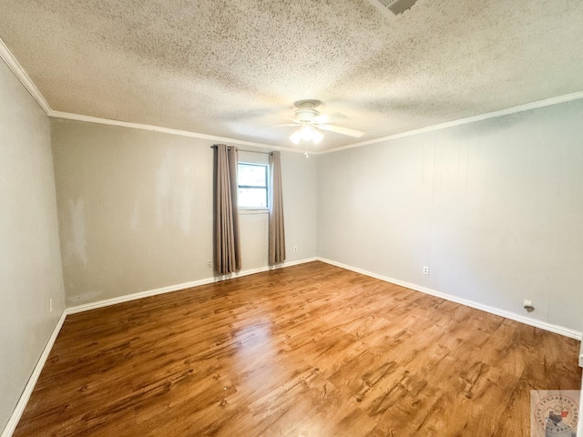 empty room featuring ceiling fan, crown molding, a textured ceiling, and wood-type flooring