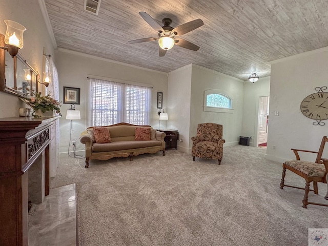 carpeted living room with wooden ceiling, a premium fireplace, visible vents, and ornamental molding