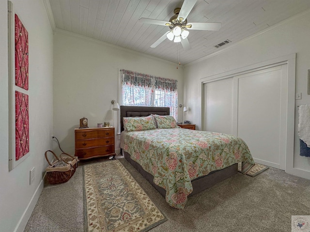 bedroom with visible vents, ornamental molding, a closet, wooden ceiling, and carpet flooring